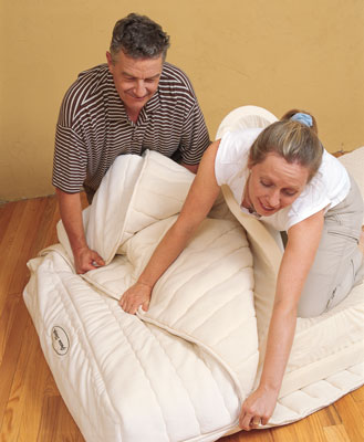
Hermine and Jean-Charles easily zip together a Green Sleep Hevea natural rubber mattress. The cover is made of organic cotton, silk, and wool layers that surround a rubber mattress core—a design that allows the layers to come apart quickly and air out in good weather.
